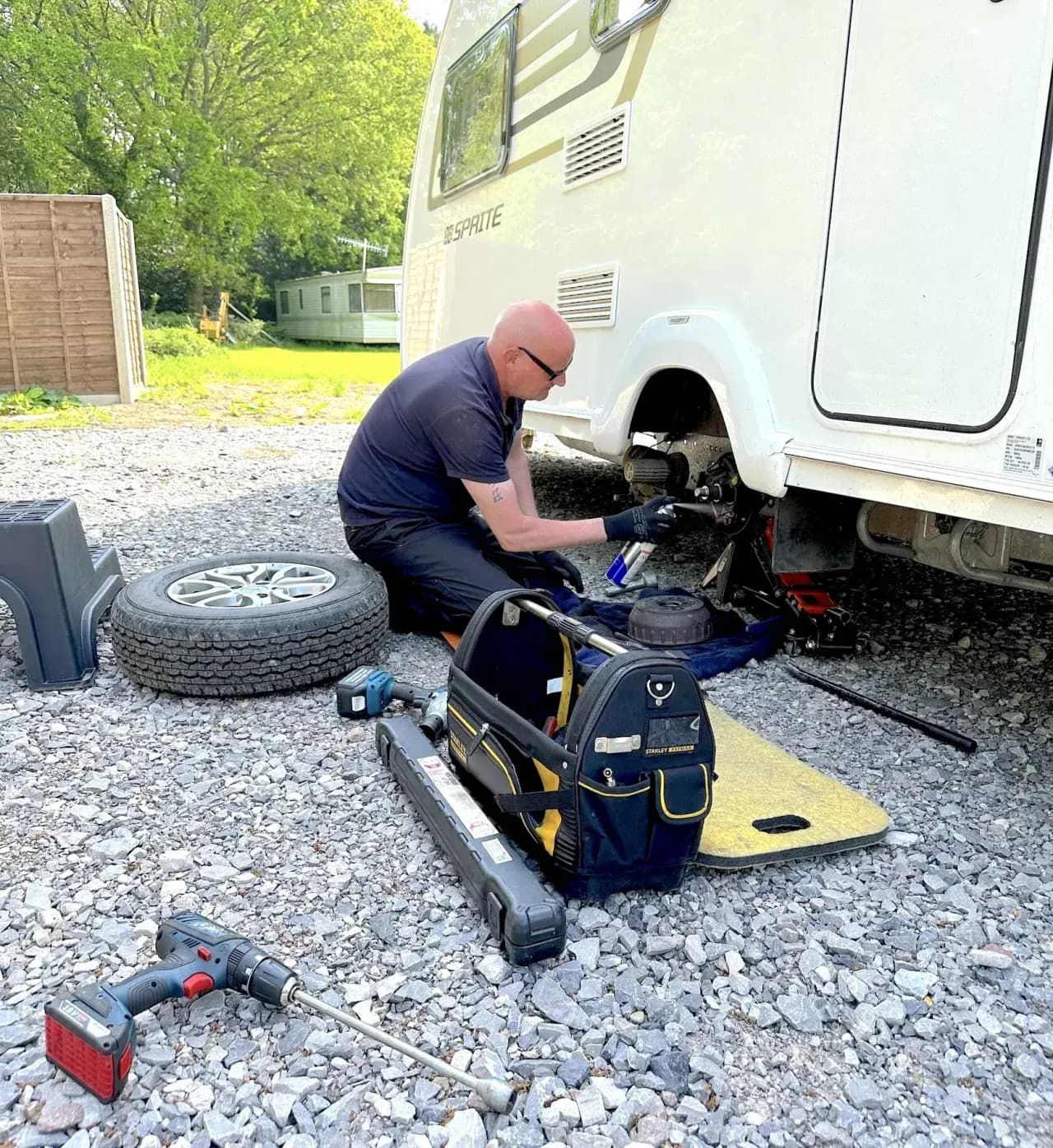 Caravan wheel, brake and chassis servicing on a Sprite caravan during a mobile service